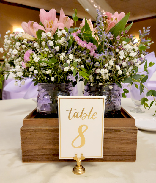 Wedding reception area with purple ribbon around chairs