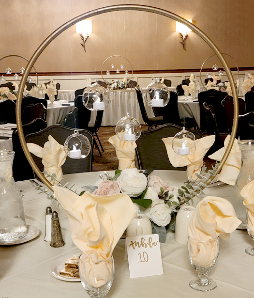 Wedding reception area with flower arrangement on red table cloth